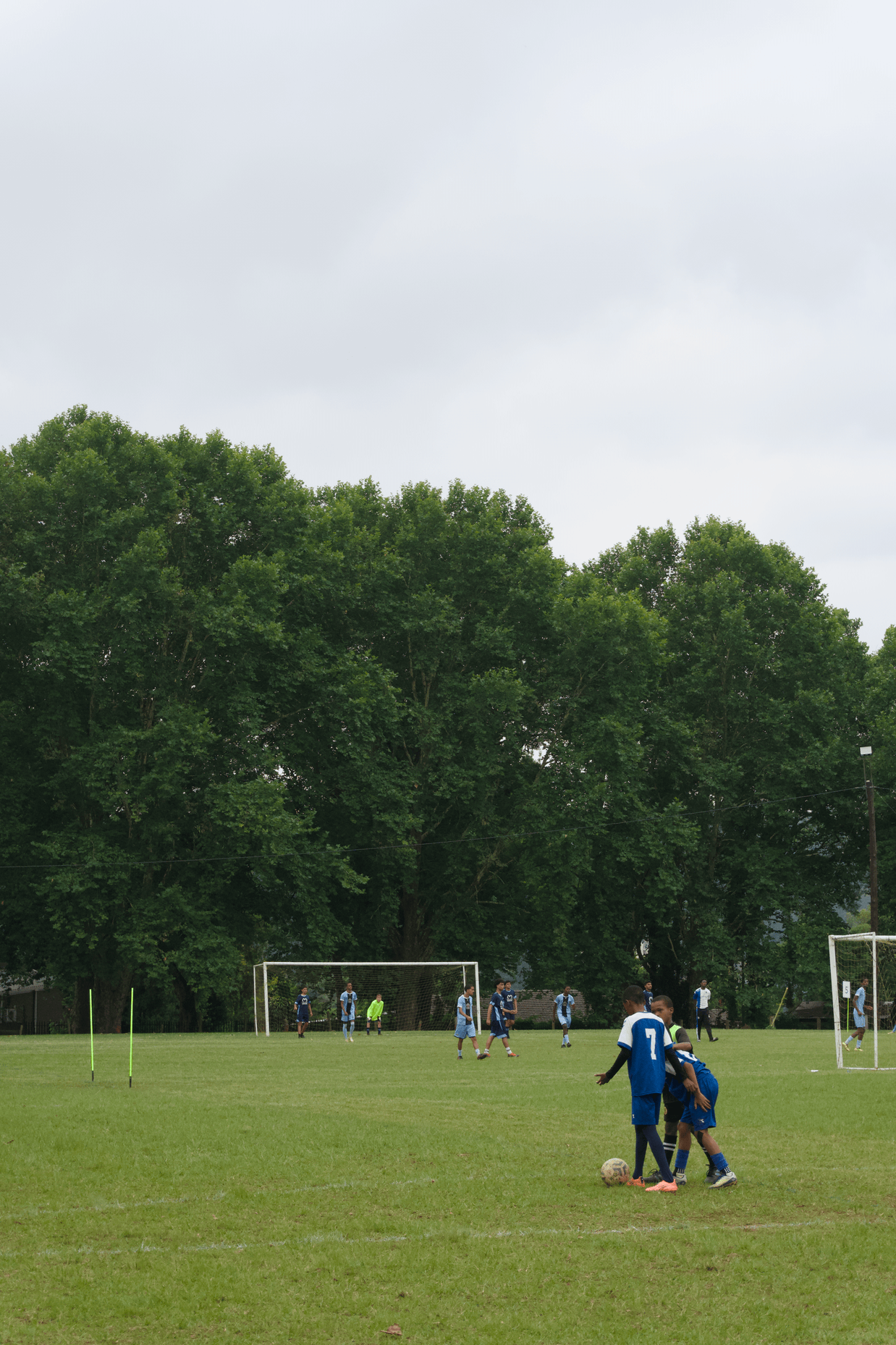 Boys helping each other out on a pitch 