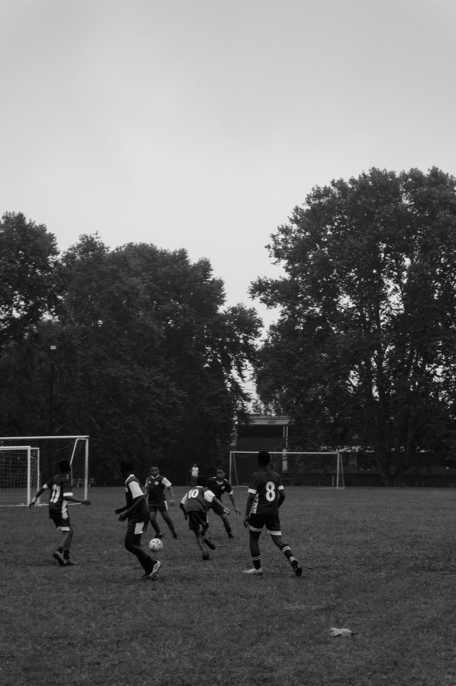 Black and white photograph of people playing soccer
