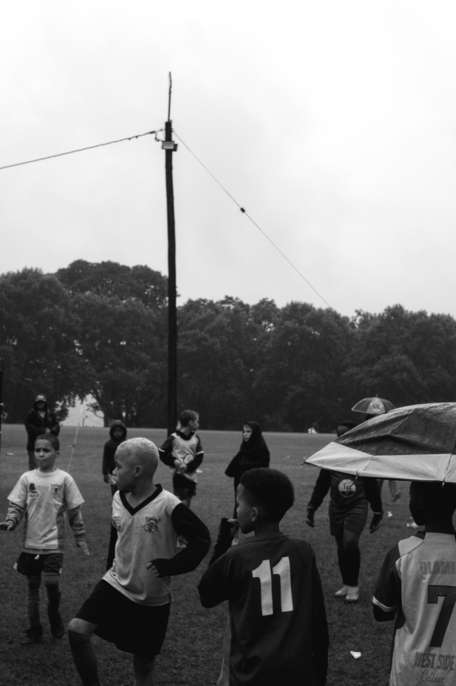 A black and white image of boys getting ready to play soccer