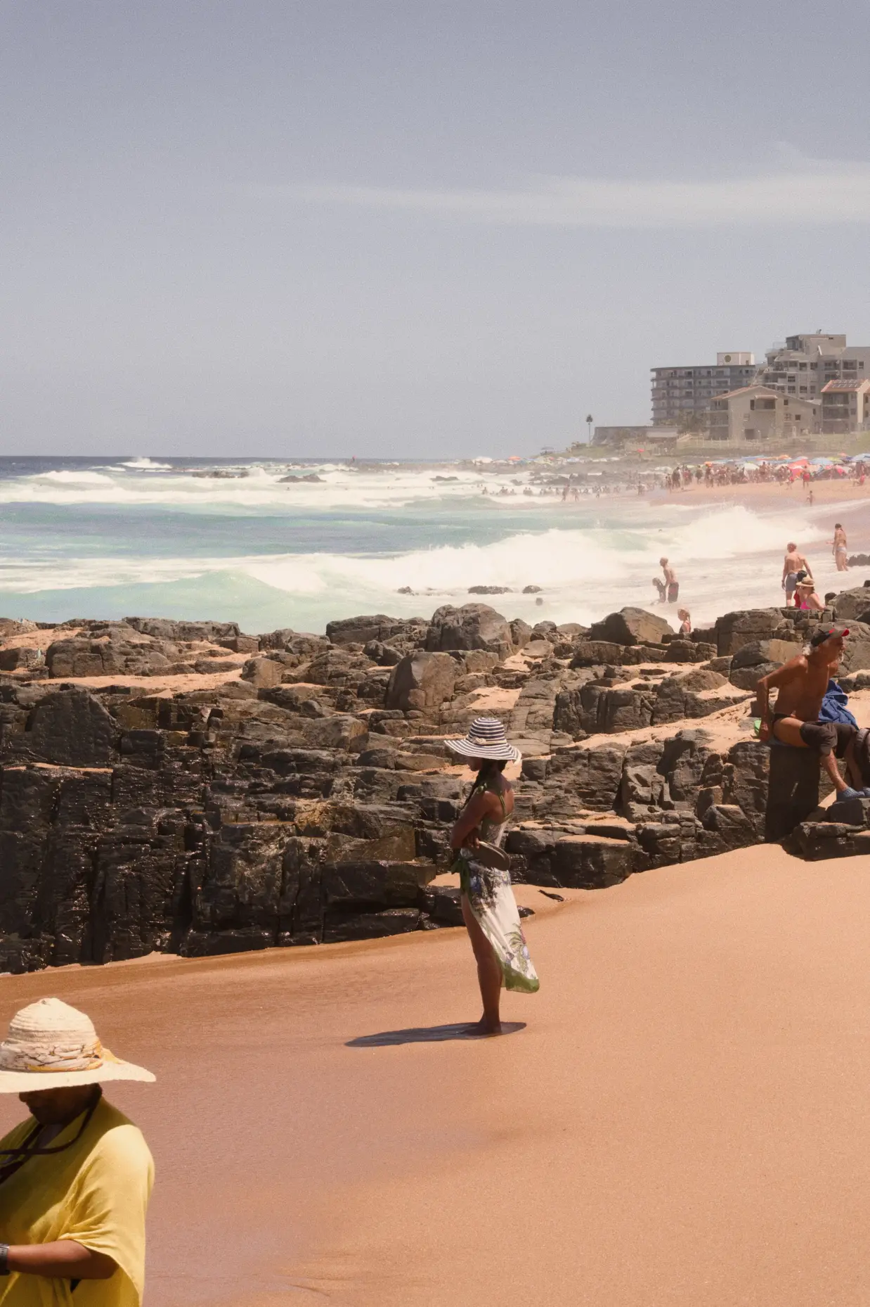 A long shot of a lone footballer who takes on defenders, on a soccer pitch.